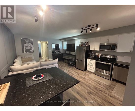 A kitchen with a black granite countertop and stainless steel appliances.