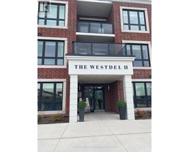 The Westdel II building has a white entrance with a black railing.
