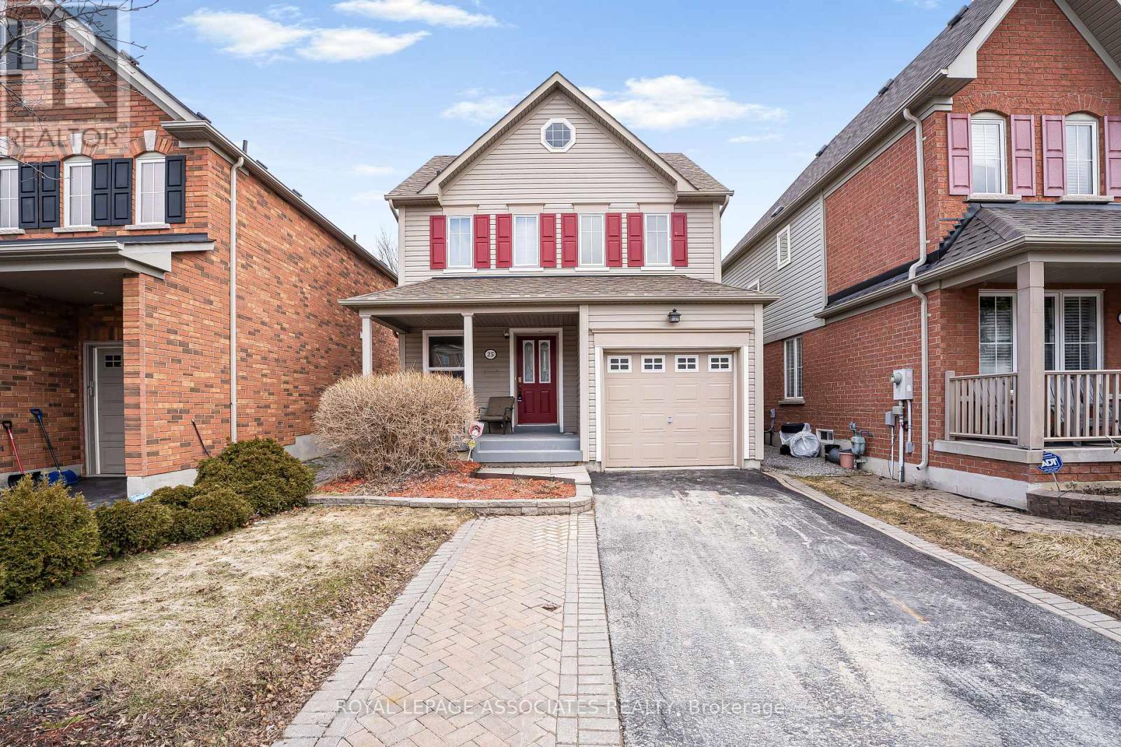 A house with a red and white striped awning is for sale.