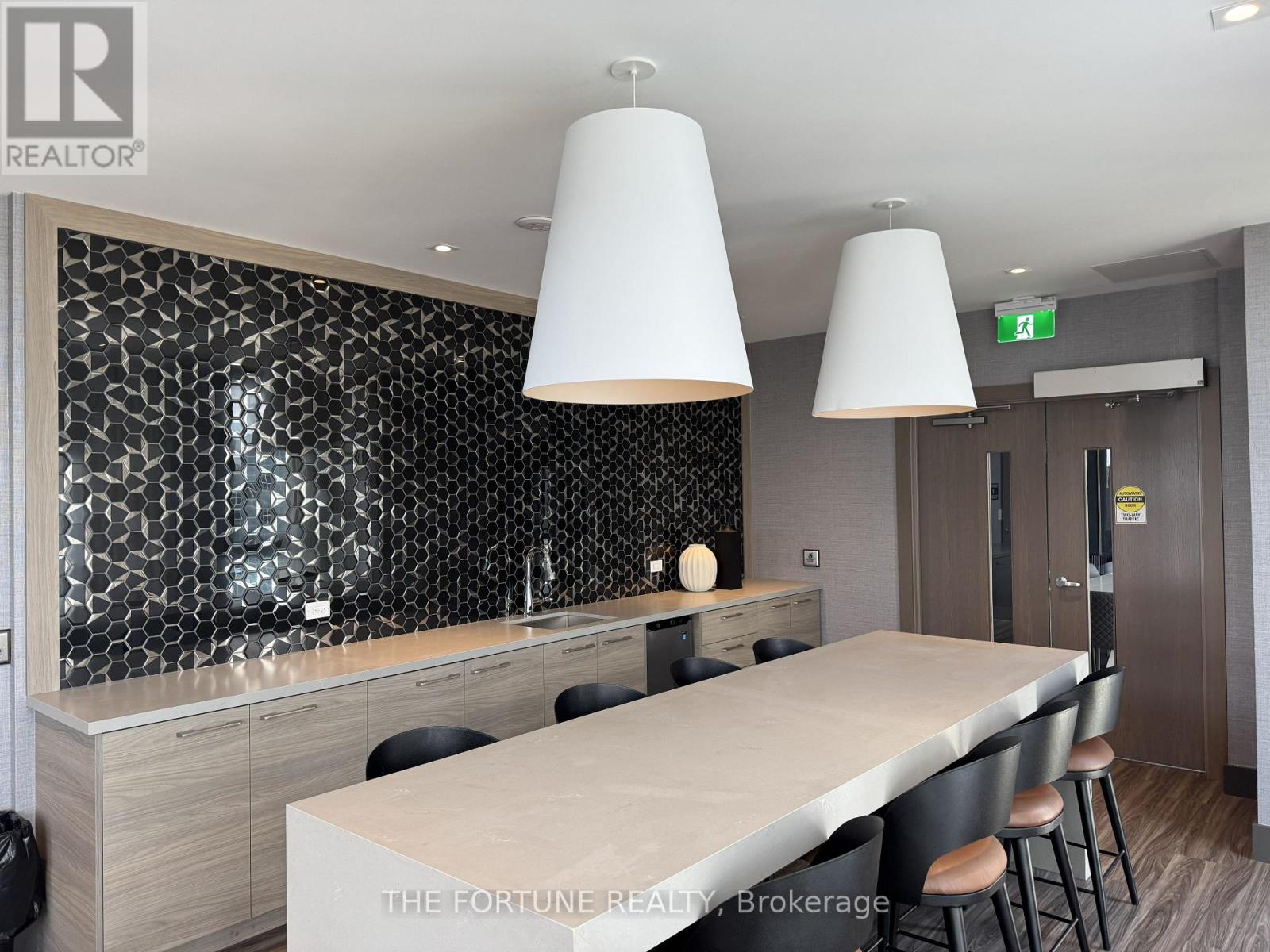 A modern kitchen with a long table and chairs.