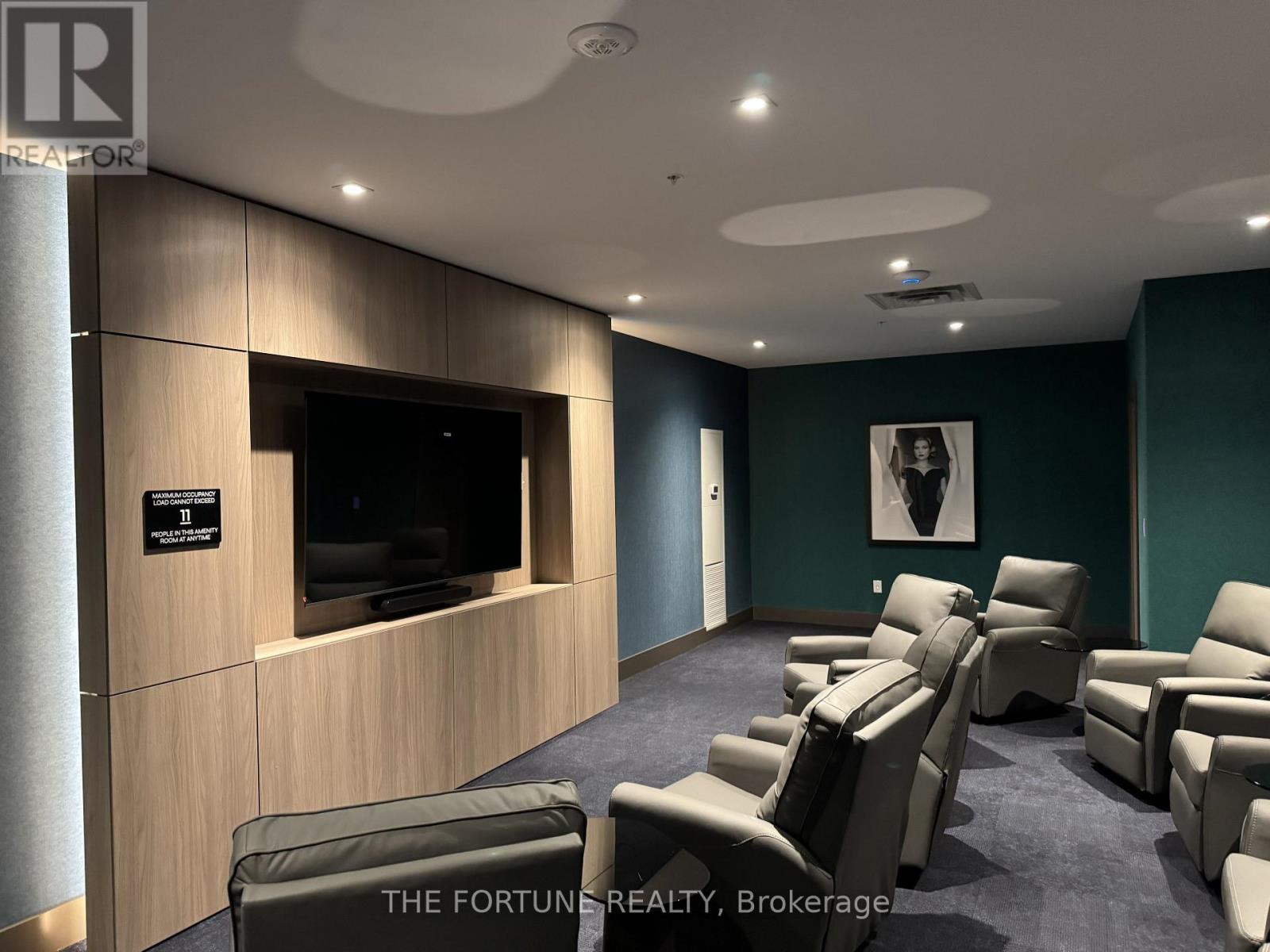 A living room with a row of chairs and a flat screen TV.
