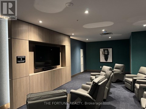 A living room with a row of chairs and a flat screen TV.