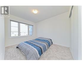 A bedroom with a bed and a window.