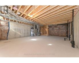 A spacious attic room with wooden beams and insulation.