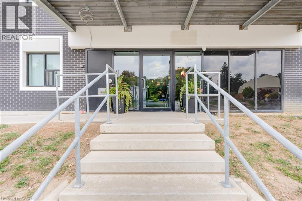 A set of stairs leads to a glass door entrance.
