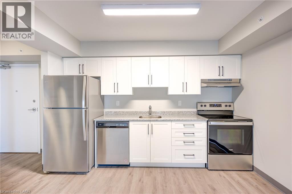 A kitchen with white cabinets and stainless steel appliances.