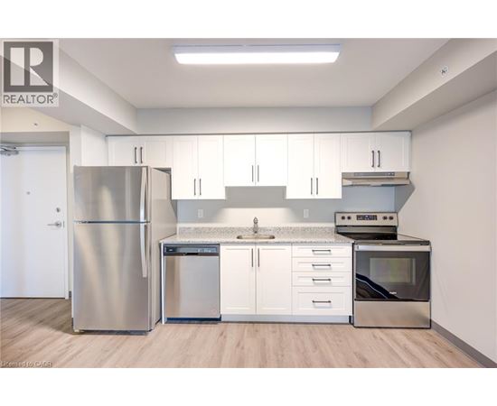 A kitchen with white cabinets and stainless steel appliances.