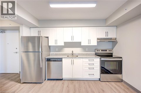 A kitchen with white cabinets and stainless steel appliances.