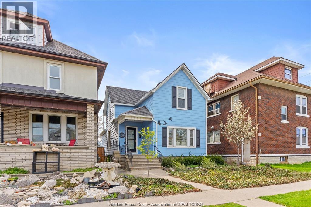 Three houses with different colored exteriors are shown in the image.