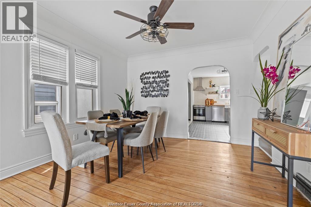 A dining room with a wooden table and chairs.