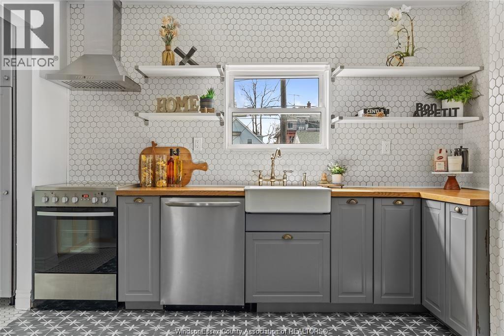 A modern kitchen with a stainless steel oven and sink.