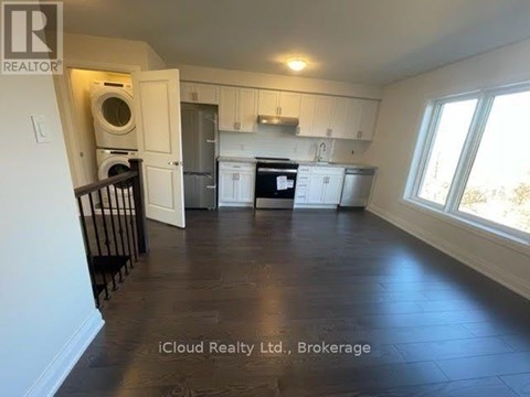 A kitchen with white cabinets and a black stove top oven.