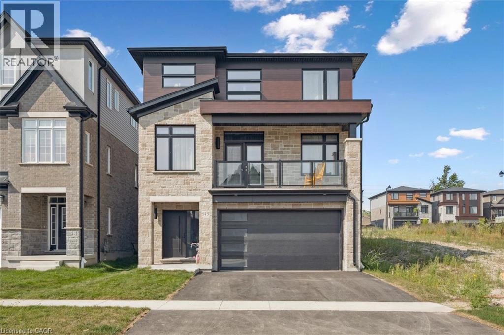 A modern two-story house with a garage is situated in a residential area.
