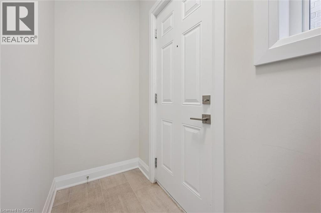 A white door with a silver handle is in a room with white walls.