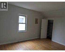 A room with a window and a closet.