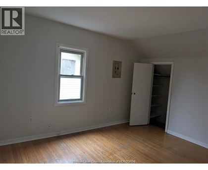 A room with a window and a closet.