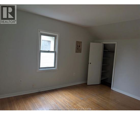 A room with a window and a closet.