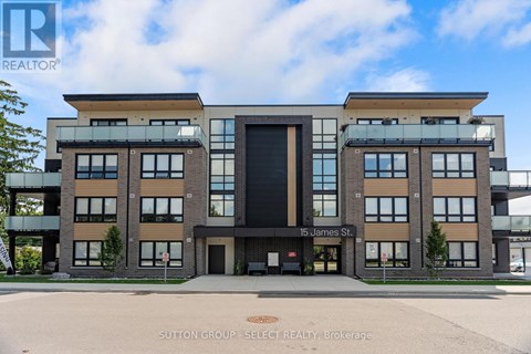 A modern building with a glass entrance and a sign that reads "15 James St." in front of it.