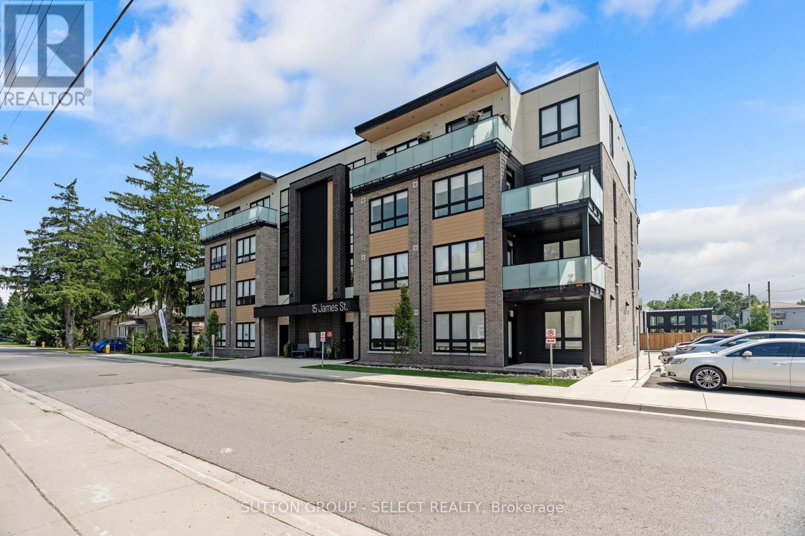 A modern multi-story building with a car parked in front.