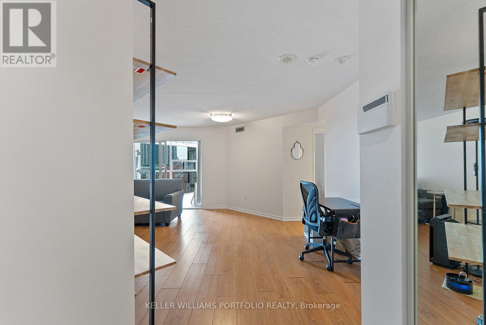 A room with a desk and a chair in it.