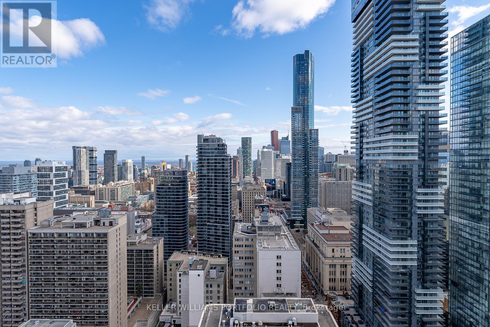 A cityscape with tall buildings and a clear sky.