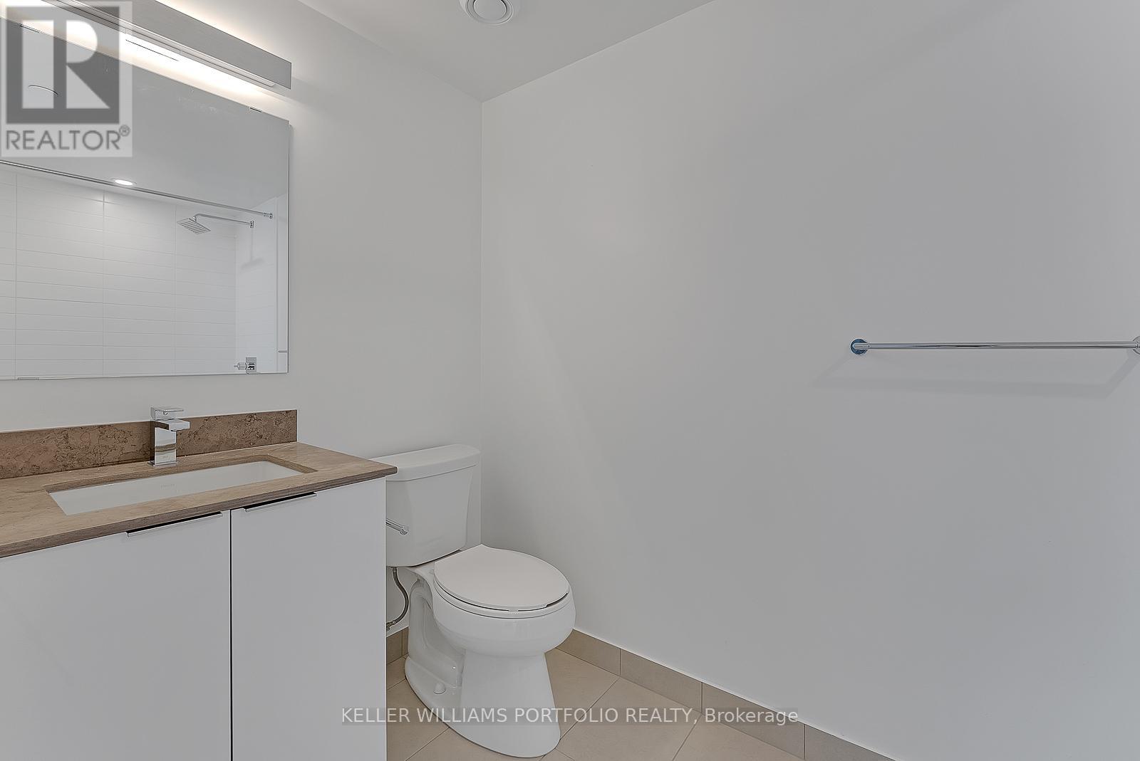 A white bathroom with a toilet and sink.