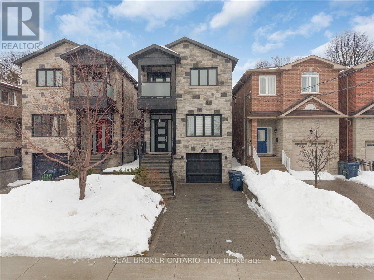 A snow-covered front yard of a residential building.