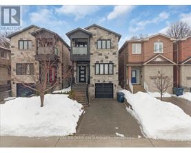 A snow-covered front yard of a residential building.