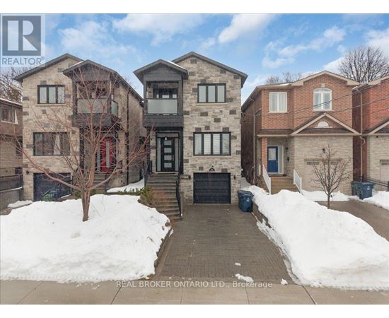 A snow-covered front yard of a residential building.