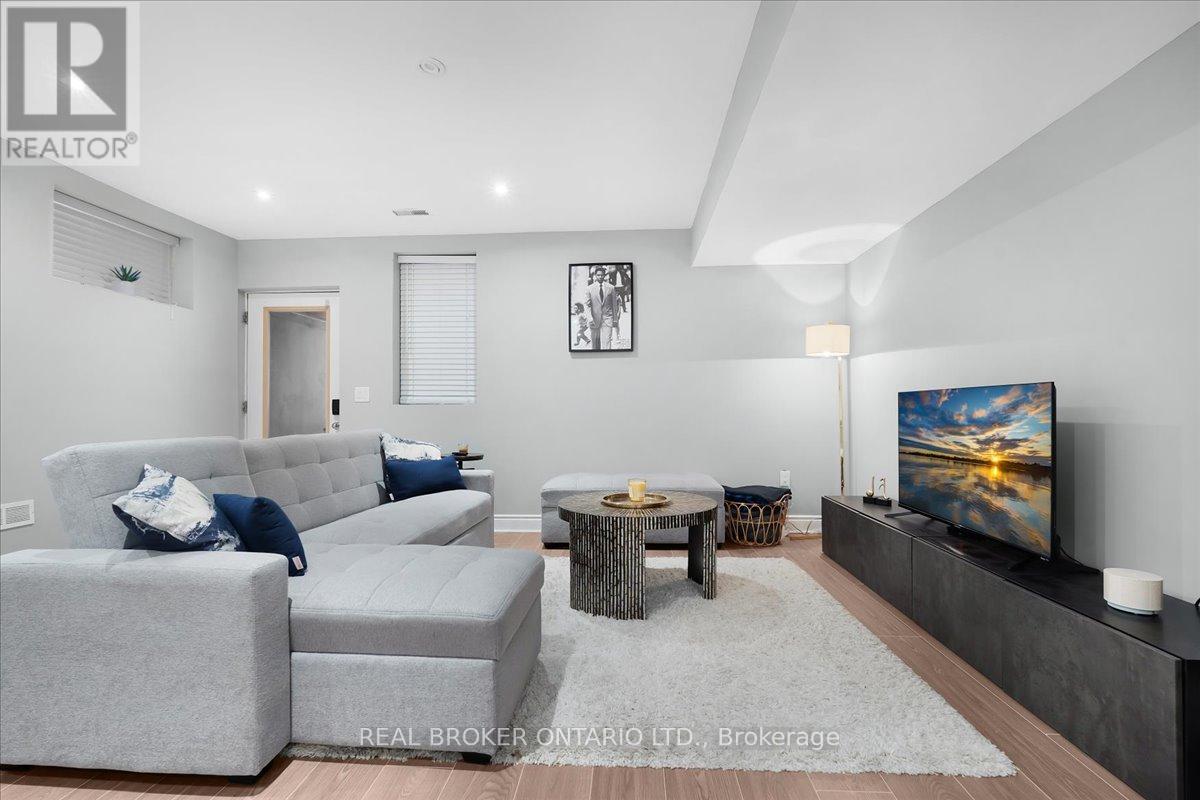 A living room with grey couches and a flat screen TV.