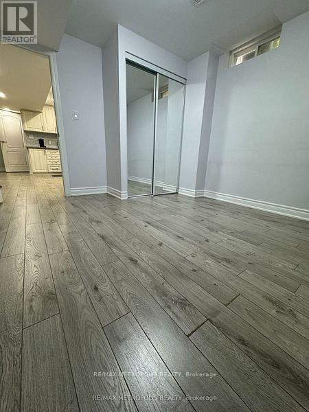 A room with wooden flooring and a glass door.