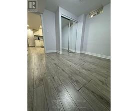 A room with wooden flooring and a glass door.