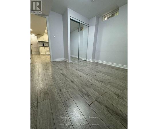A room with wooden flooring and a glass door.