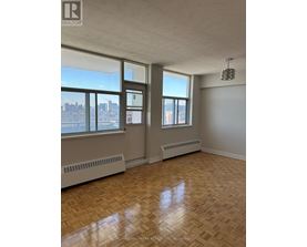A room with a window and a radiator on the wall.