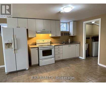 A kitchen with white appliances and cabinets.