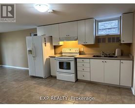 A kitchen with white appliances and cabinets.