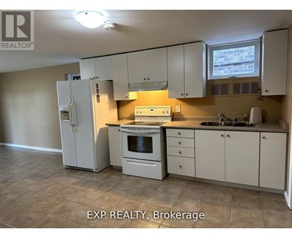A kitchen with white appliances and cabinets.