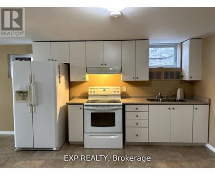 A kitchen with white cabinets and appliances is for sale.