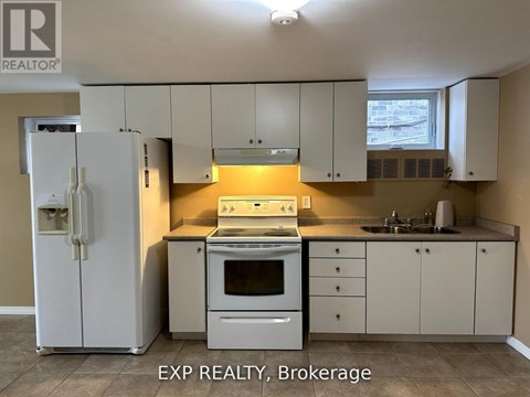 A kitchen with white cabinets and appliances is for sale.