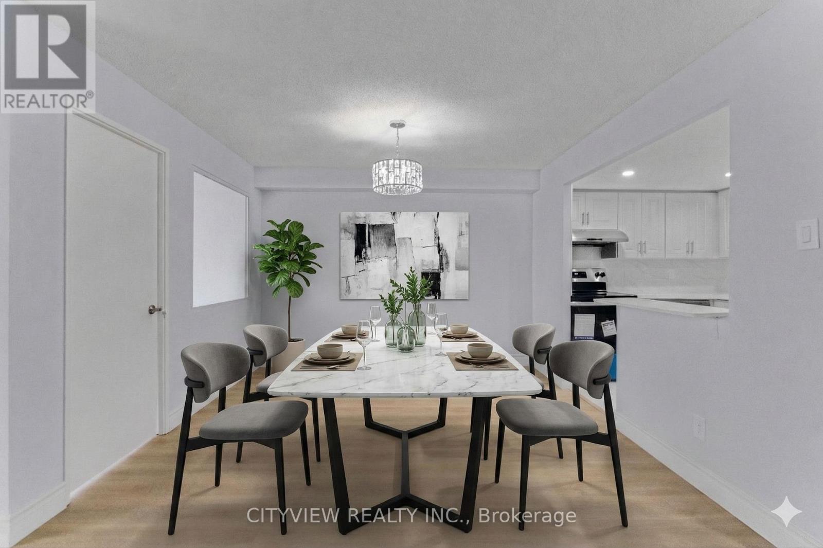A dining room with a white table and chairs.