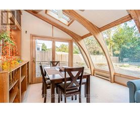 A dining room with a wooden table and chairs.