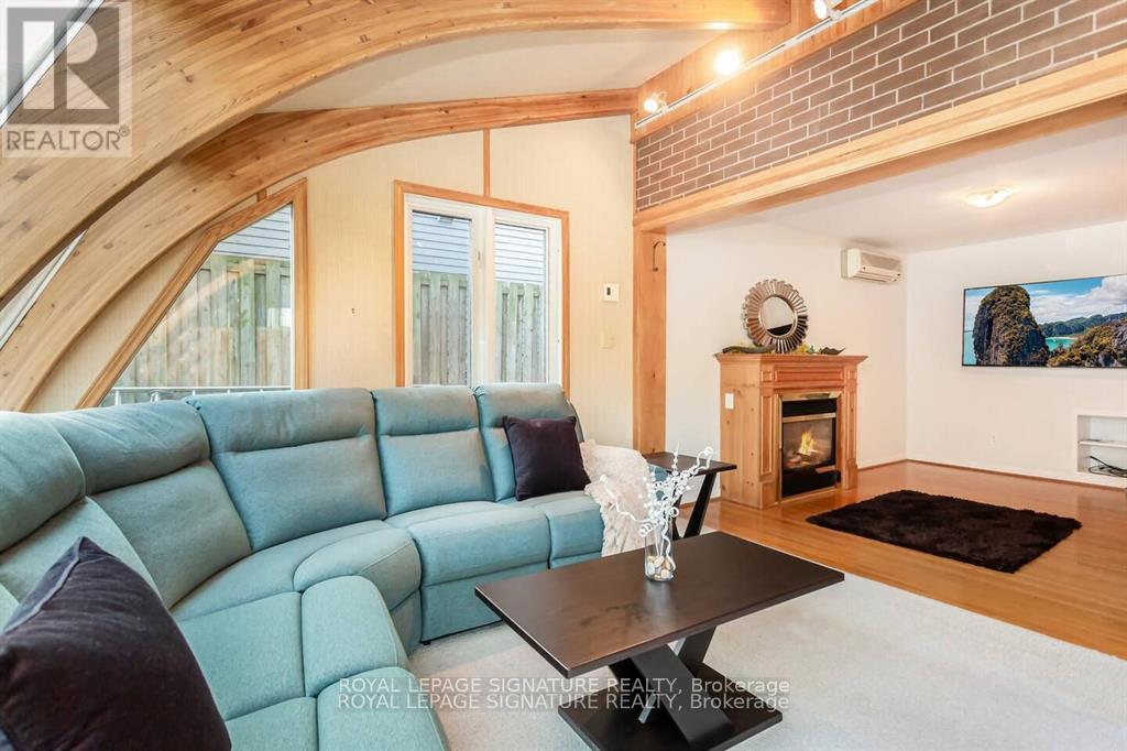A living room with a blue couch and a fireplace.