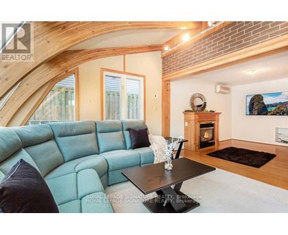 A living room with a blue couch and a fireplace.