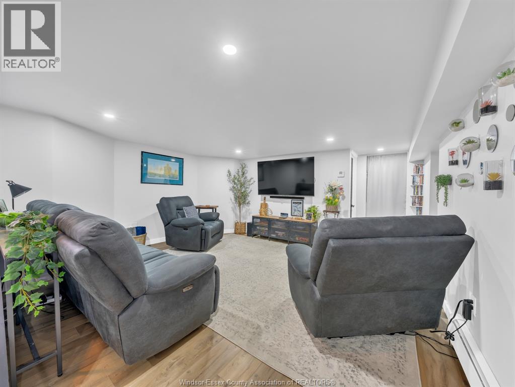 A living room with grey couches and a flat screen TV.