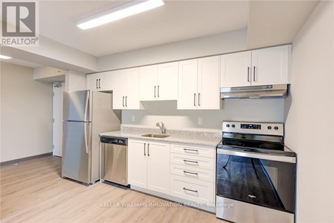 A kitchen with white cabinets and stainless steel appliances.