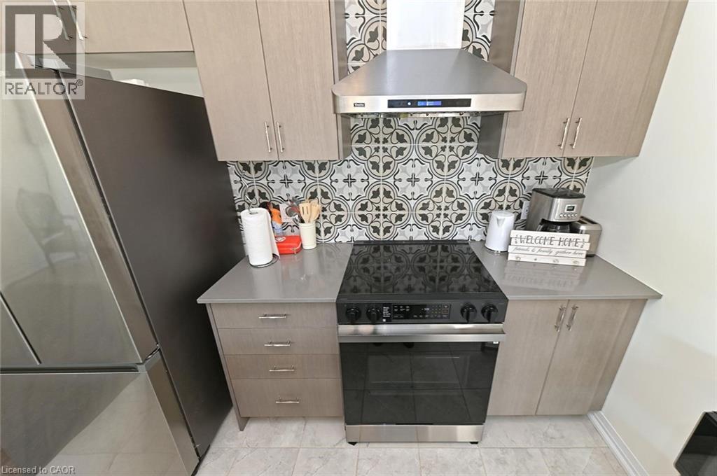 A kitchen with a stove top oven and a refrigerator.