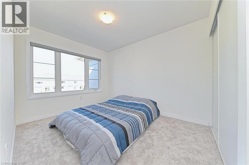 A bedroom with a bed and a window.