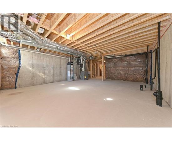A spacious attic room with wooden beams and insulation.