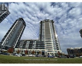 A modern building complex with cars parked in front.