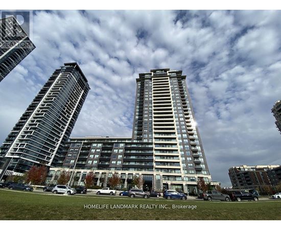 A modern building complex with cars parked in front.